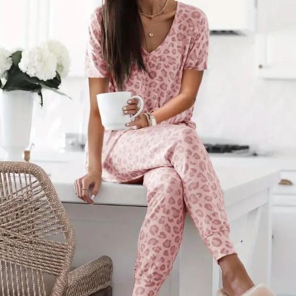 Women's V-NeckLeopard Print Loungewear Set. This relaxed-fit two-piece features a short-sleeve top and pants for effortlessly chic, casual comfort.